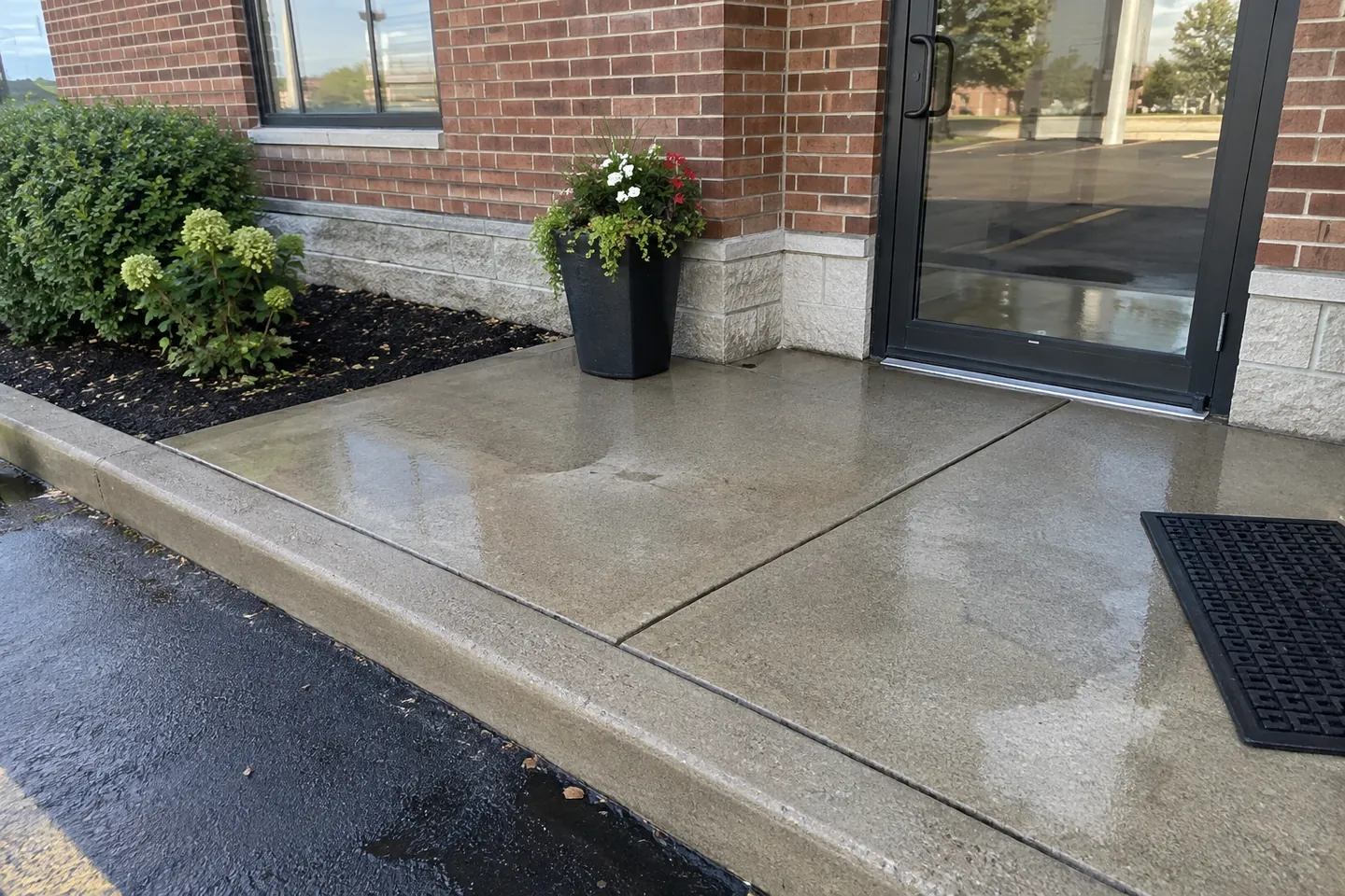 Concrete entrance pad and glass door at a small business
